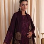 Model wearing maroon embroidered leather peach suit with jacquard shawl from Dastaan By Riaz Arts DS-01 winter collection.