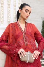 Maria B Embroidered Lawn Suit EL-26-13 in rich rust tones with elegant embroidered organza detailing. A luxury Pakistani Eid outfit featuring burnout silk dupatta and sophisticated festive embroidery, kameez front closeup
